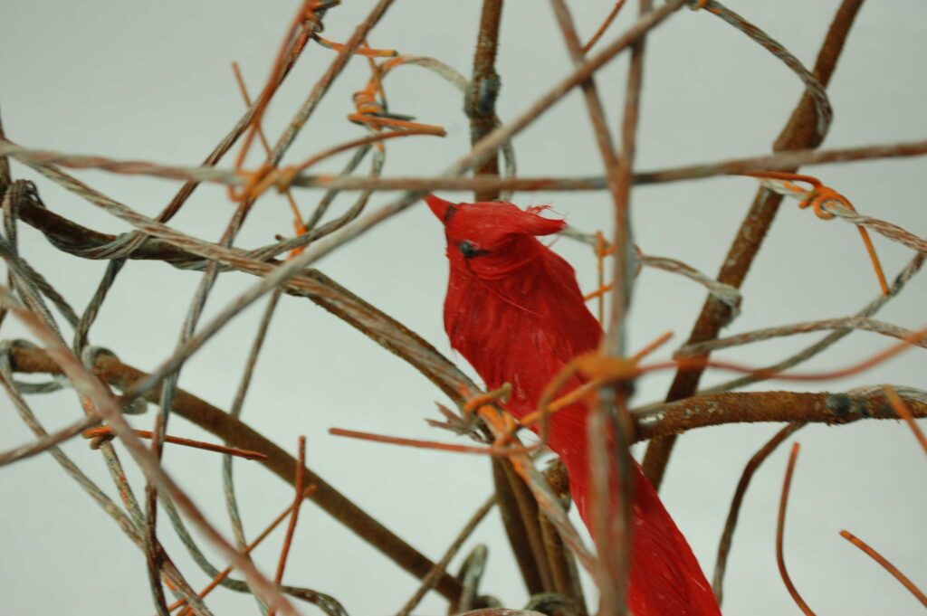 A close up image of the bird sculpture with the red bird in the center.