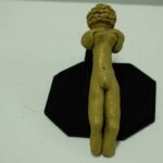 A modern take on the Venus of Willendorf statue made of clay