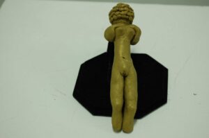 A modern take on the Venus of Willendorf statue made of clay